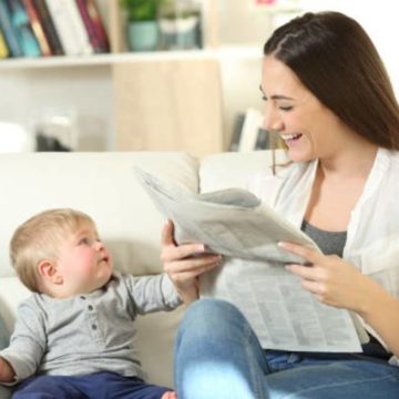 woman-baby-reading-newspaper