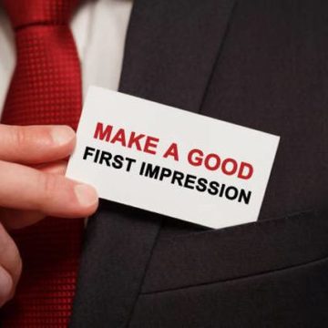 businessman-putting-a-card-with-text-make-a-good-first-impression