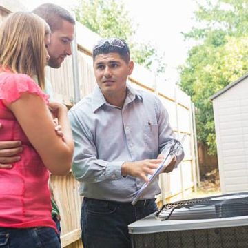 air-conditioner-repairman-explaining-cost-of-repairs-to-homeowners