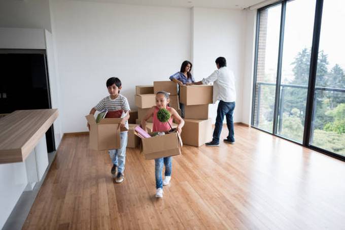 happy-family-moving-boxes-house